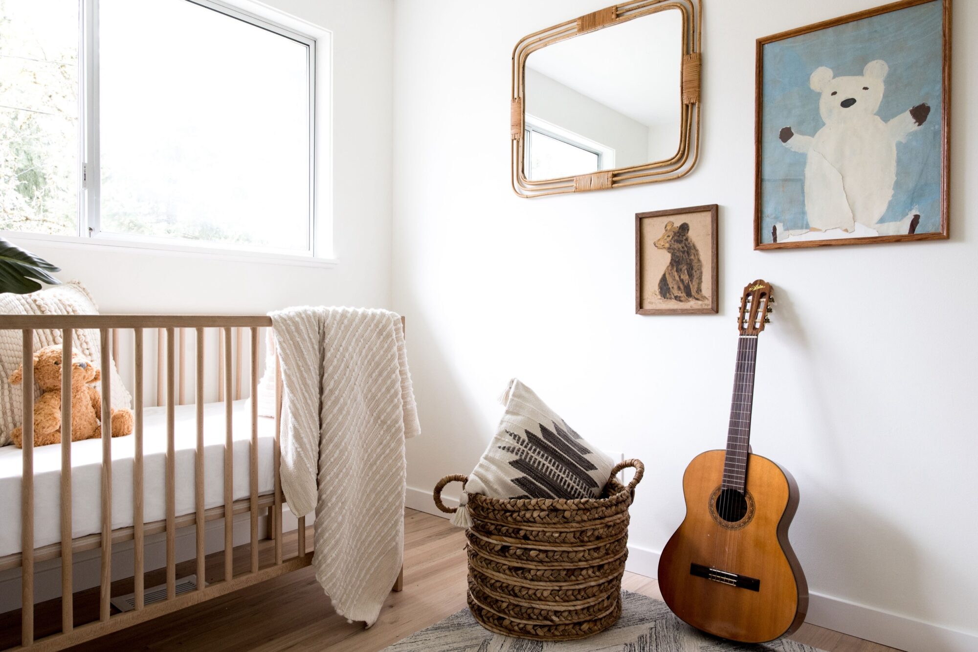 Seattle's best commercial food and hospitality photographer A bright, minimal nursery with a wooden crib, a teddy bear, a blanket, and animal-themed wall art is beautifully captured by Seattles best commercial food lifestyle photographer, with natural light streaming through the window. captured by seattle's best food and lifestyle photographer Brooke Fitts