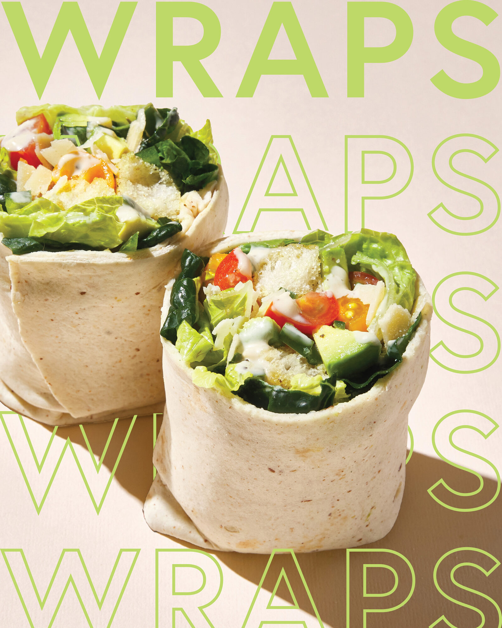 Seattle's best commercial food and hospitality photographer Two tortilla wraps filled with lettuce, tomatoes, cheese, and veggies are displayed on a light background, captured by Seattles best commercial food lifestyle photographer. The word WRAPS appears in bold green letters behind them. captured by seattle's best food and lifestyle photographer Brooke Fitts